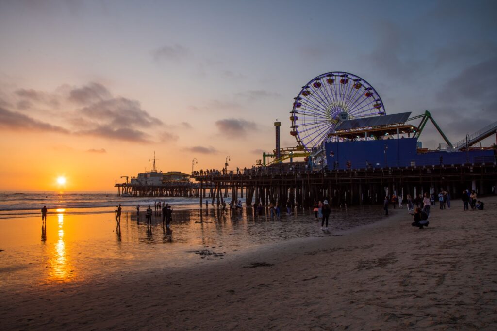 People learning to surf on Santa Monica Beach at Sunset