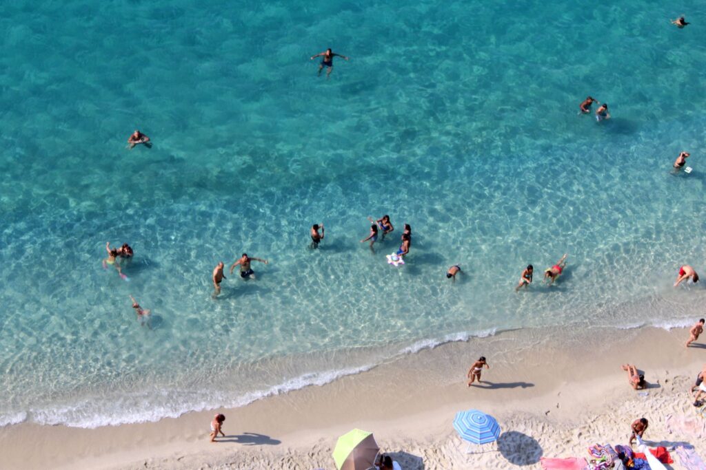 Beach with clear green water and Beach with full of people