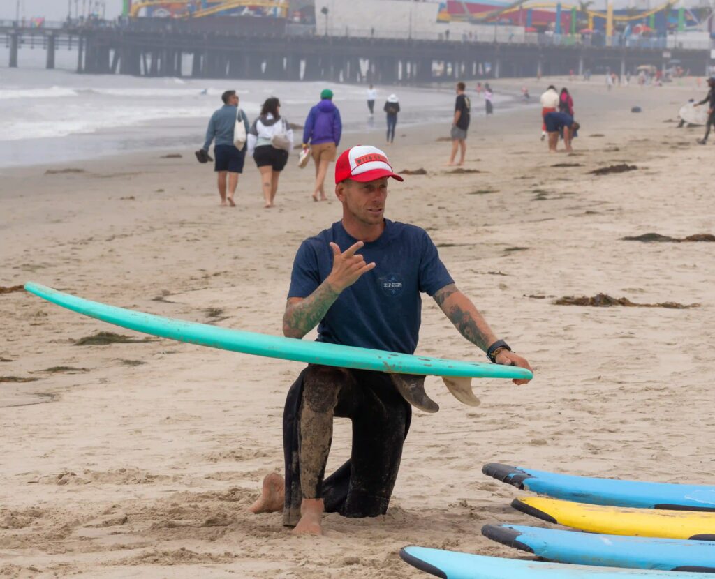 Juan Spinola, founder of Offshore Vibes Surf School, teaching students to learn to surf in Los Angeles.